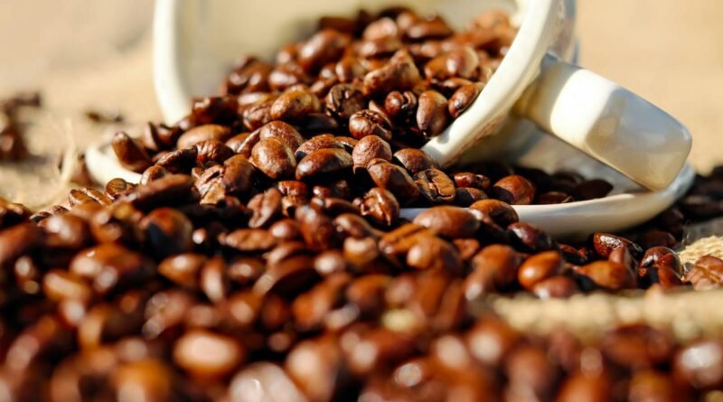 Shallow Focus of Coffee Beans on White Ceramic Cup