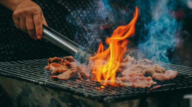 Close-Up Photo of Man Cooking Meat