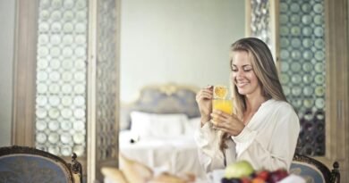 Cheerful woman enjoying breakfast in morning