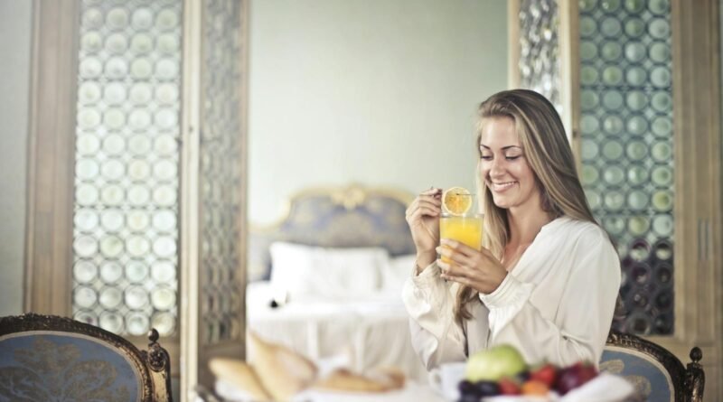 Cheerful woman enjoying breakfast in morning