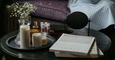 White Pillar Candles on Black Wooden Table