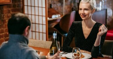 Couple having dinner with pasta and wine in room