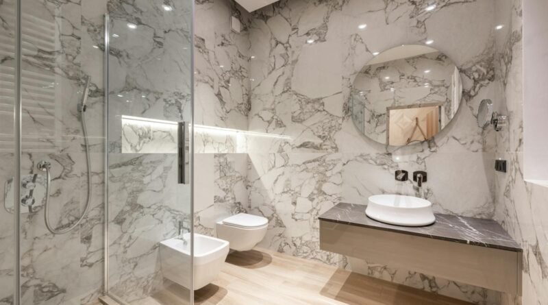 Bathroom interior with bidet and toilet near sink and shower