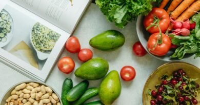 Top View of a Cookbook and Variety of Healthy Foods on a Table