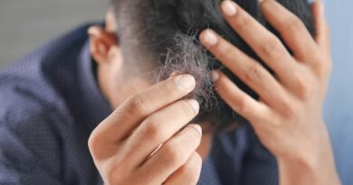 a man is combing his hair with his hands