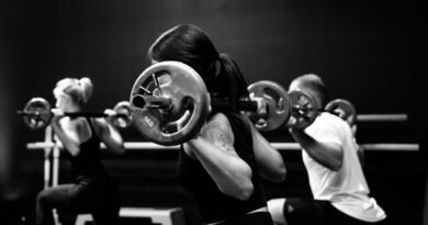 three person lifting barbels