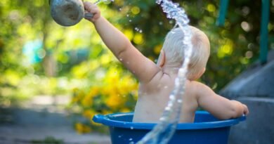 child lifting water dipper