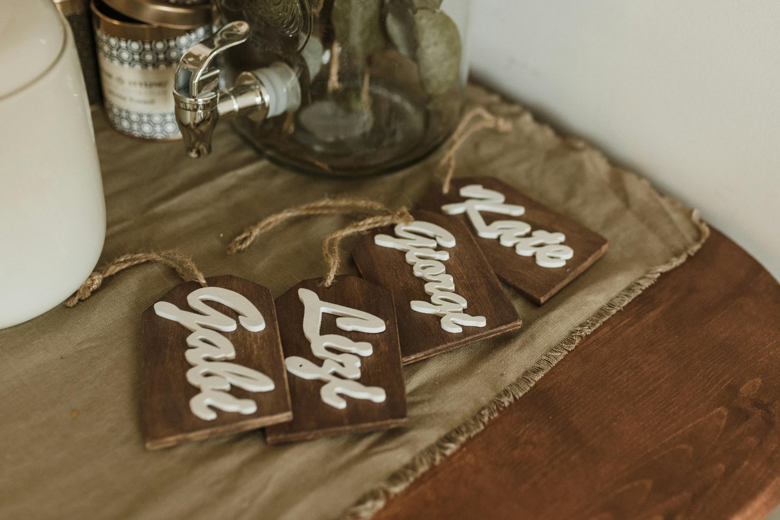 Charming wooden name tags with elegant script on a rustic tabletop setting.